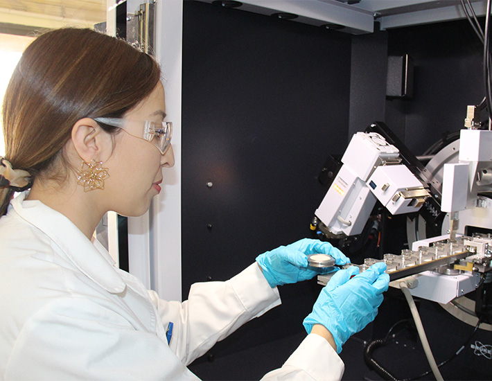 A woman is seen in the image analyzing samples