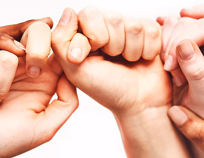 Hands of different races in a collaborative attitude