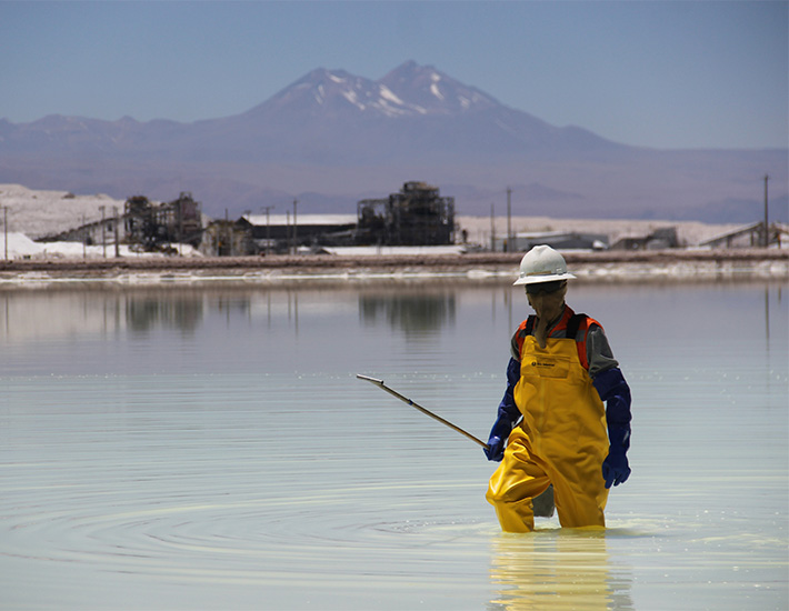 Man with yellow raincoat in a salt flat